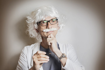 Funny portrait of a mad geek scientist who like Einstein dreams