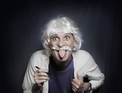 Funny portrait of a mad geek scientist who like Einstein shows protruding tongue