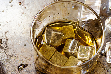 Whisky stones in glass on black background