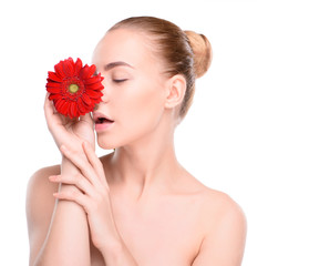 Fototapeta na wymiar Woman posing with red gerbera. Isolated on white background
