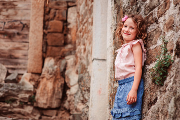 tourist child girl on the walk on streets of Piran, Slovenia in summer
