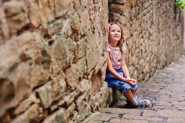 child girl with bouquet of tulips on cozy winter walk in forest, birthday celebration in winter