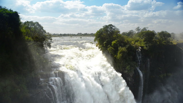 Victoria Falls Devils Cataract or Mosi-oa-Tunya waterfall in southern Africa on the Zambezi River at the border of Zambia and Zimbabwe in high definition footage with ambient audio. 