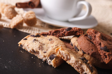 Cookies with chocolate chips and a cup of coffee close-up. horizontal
