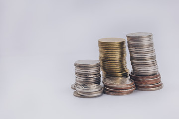 group of coins stacking up in white isolated background.