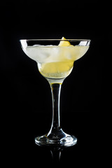 Cocktail margarita with lemon on black background