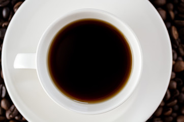 White mug of coffee and saucer