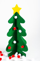 Small green Christmas tree with a golden star decoration isolate