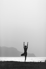 Woman yoga meditation in vrksasana pose silhouette