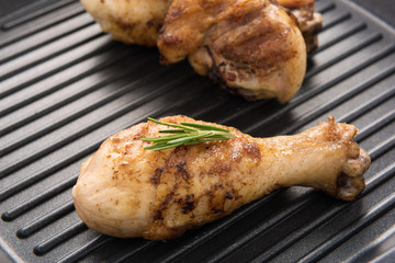 Grilled chicken drumstick and rosemary  in a pan