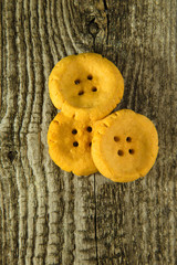 Cheese pastry shape like a button on old light grey wooden table