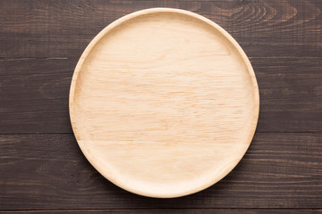 Wood dish on the wooden background. Top view