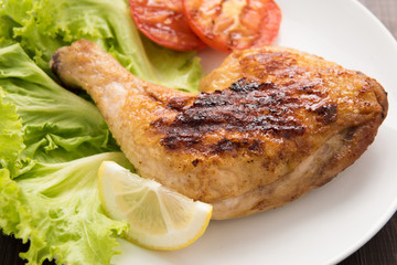 Grilled chicken lag and vegetable on white dish