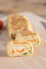 Japanese snack, eggs roll with carrot and onion.