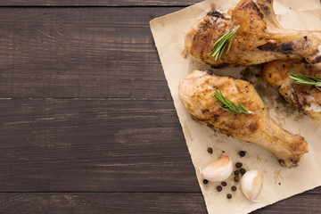 Grilled chicken drumstick and vegetable on wooden background