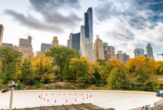 Ice Rink in Central Park with skyscrapers and foliage - NYC