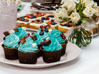 Delicious sweet holiday buffet with cupcakes, meringues and other desserts