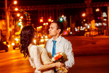 Obraz premium Elegant dressed man is tenderly embracing happy smiling woman