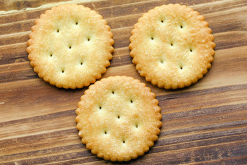 three biscuits over wooden background
