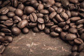 Roasted coffee beans on a rustic old wooden table