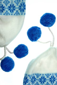 White Knitted Female Beanie With Two Blue Pompom Isolated