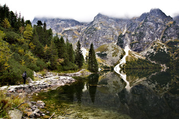 Naklejka na ściany i meble Beautiful scenery in the Tatra Mountains with hiker and reflections