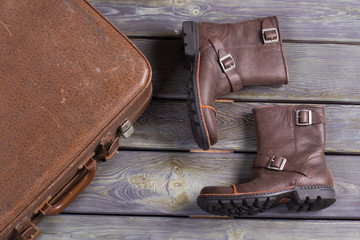 Men's leather boots and old retro suitcase.