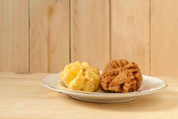Stacked chocolate cookies and milk cookies on wood
