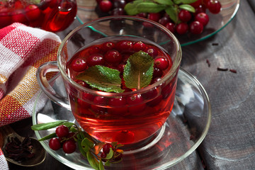 berry tea in cup on dark wooden table