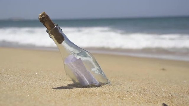Message in the bottle on a deserted beach