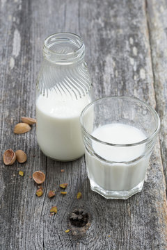fresh nut milk on wooden background