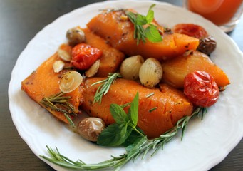 Pumpkin orange slices sweet baked in the oven with vegetables and spices