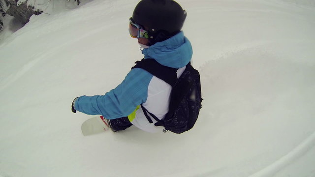 Snowboarder riding powder