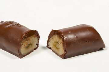 Shortbread bar covered by black chocolate cut in half. Spanish Christmas sweet