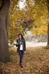 Woman texting on her phone while out walking