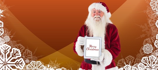 Composite image of santa presents a tablet pc
