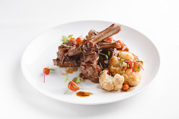Grilled rack of lamb with vegetables.