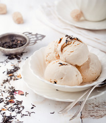 Ice cream with Earl grey tea flavor. White ceramic bowl 