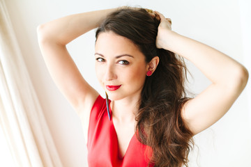 Fototapeta premium portrait of a young beautiful women in red dress with brunette h