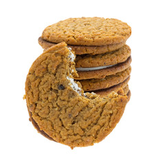 Stack of oatmeal crème cookies with one bitten