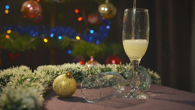 New Year and Christmas Celebration with Champagne. Wineglasses and Pouring Sparkling Wine. Holiday Decorations