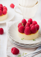 Cheesecake with fresh raspberries on a white plate. Dessert.