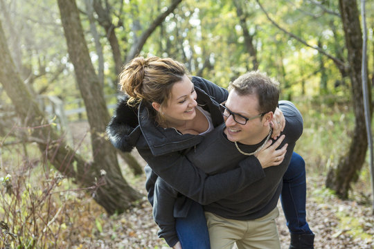 Happy middle aged couple outdoors on beautiful autumn day
