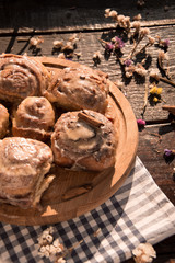 Cinnabon buns with cinnamon on a wooden board