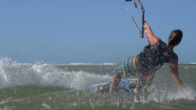 Smiling young woman kiteboarding
