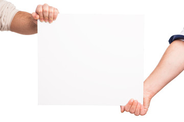 Hands holding a blank white board