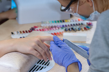 closeup of manicurist at work, Nails saloon woman nail polish re