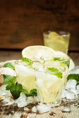 refreshing cold drink with ginger, lemon, ice and mint, selectiv