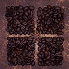 Star anise spice on dark roasted coffee beans divided into quart