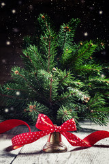 New Year Christmas bell with a red ribbon in polka dots with fir